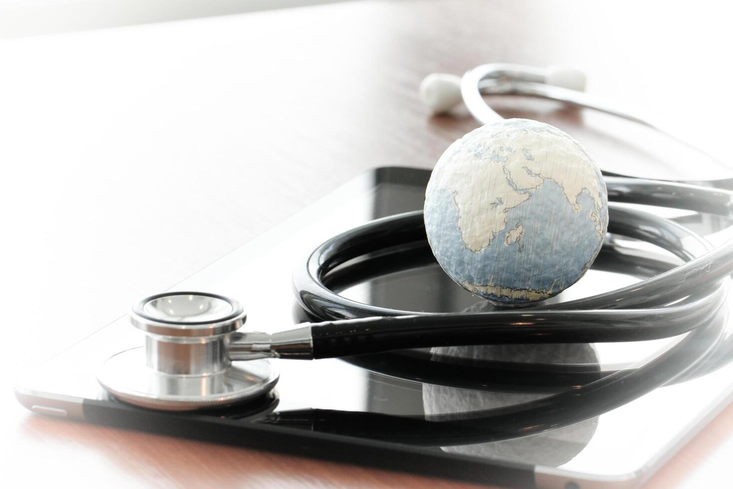 Studio macro of a stethoscope and texture globe with shallow DOF evenly matched abstract as medical network concept Elements of this image furnished by NASA photo