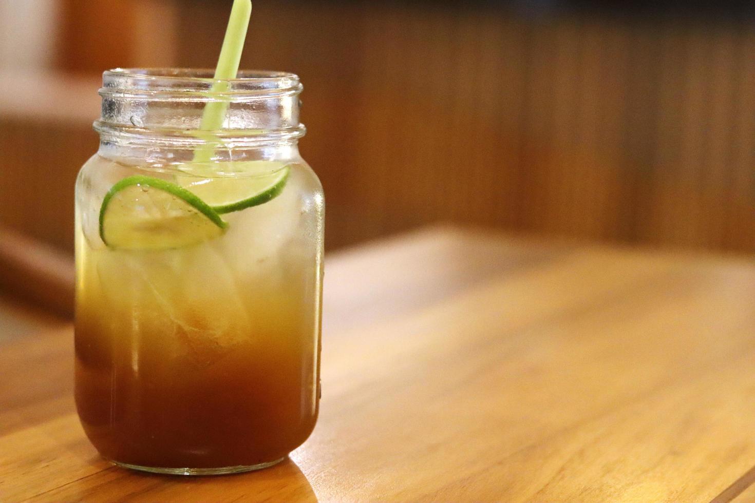 A glass of fresh honey ginger ice on the cafe table photo