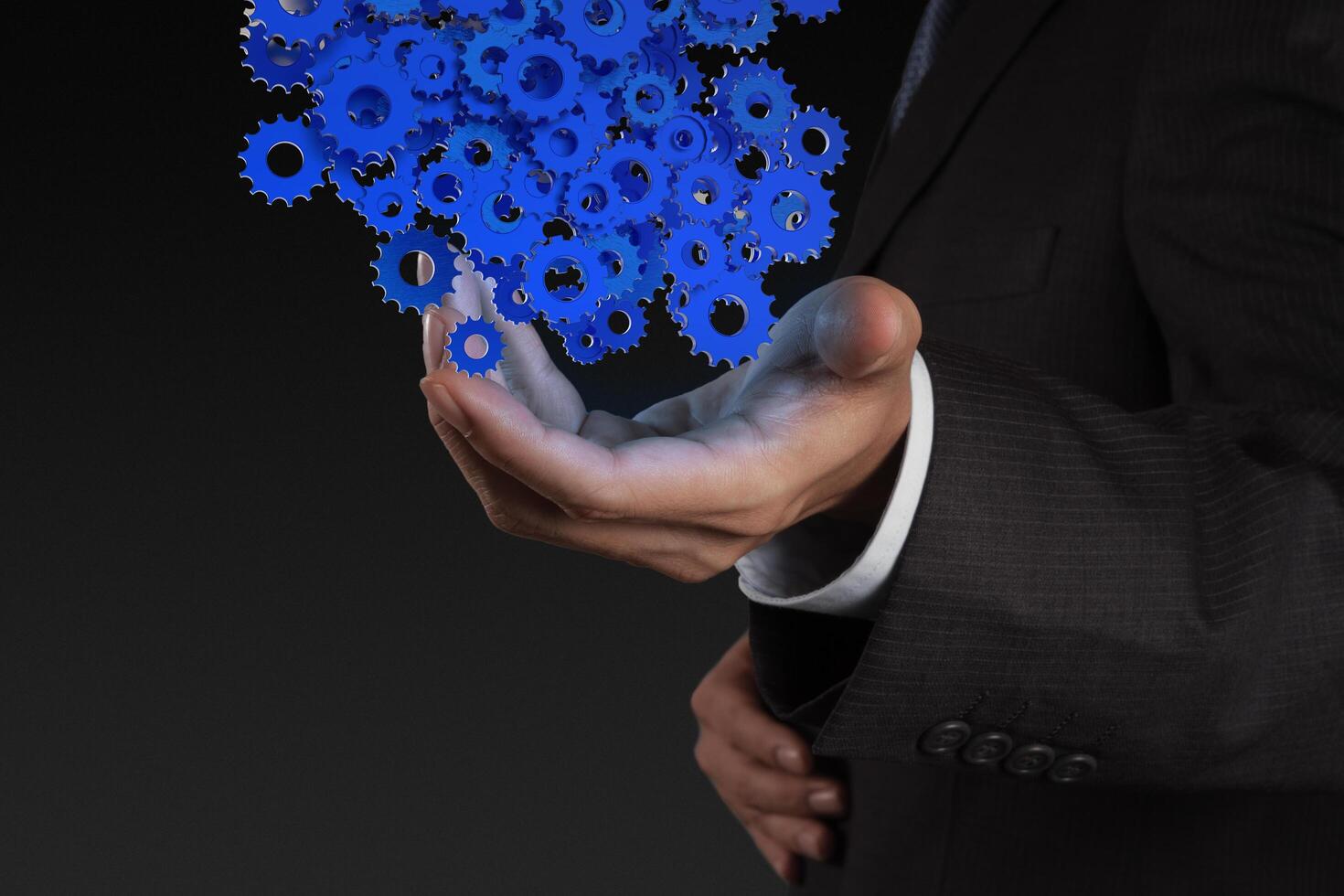 businessman hand showing gears cogs to success concept photo