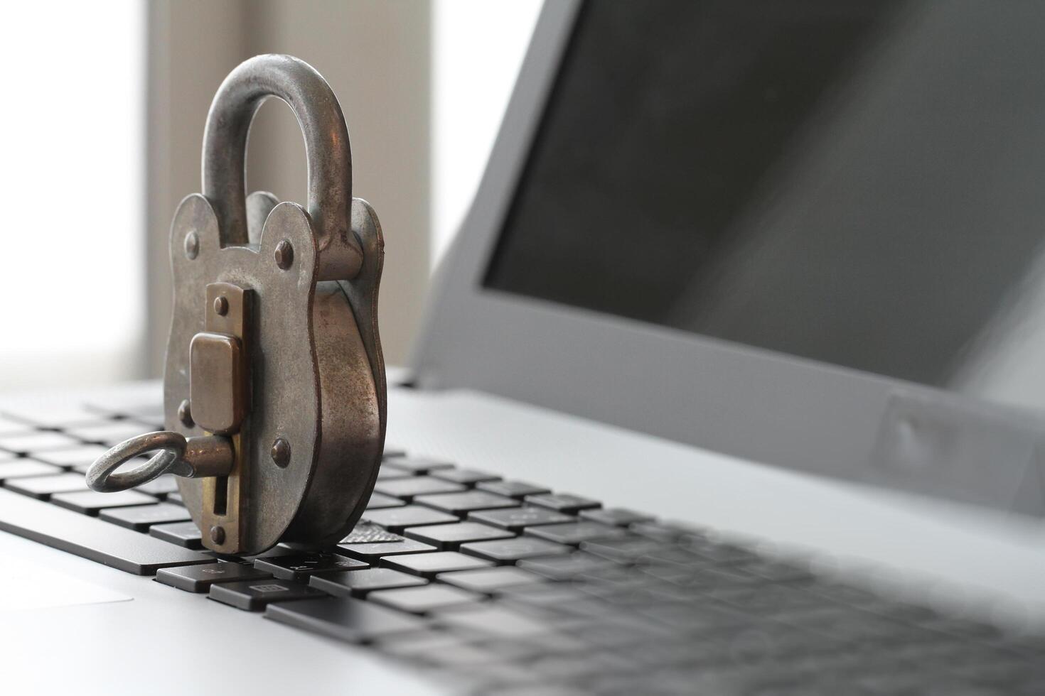 Internet security concept-old padlock and key on laptop computer keyboard photo