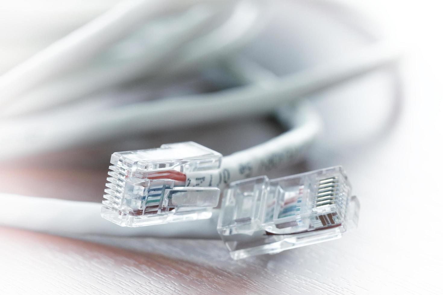 close up of RJ45 Plug Lan Network on wood desk photo