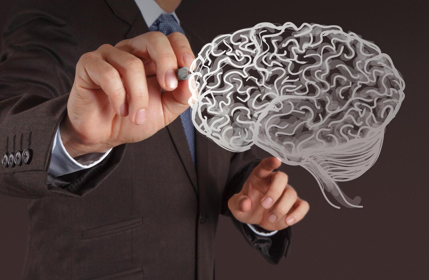 Businessman hand drawing a brain photo