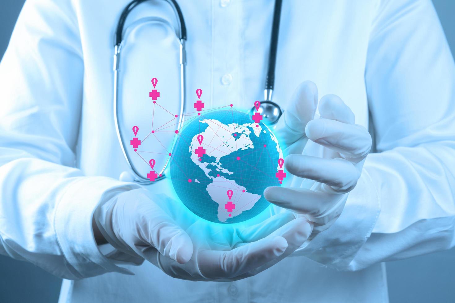 Medical Doctor holding a world globe in his hands as medical network photo