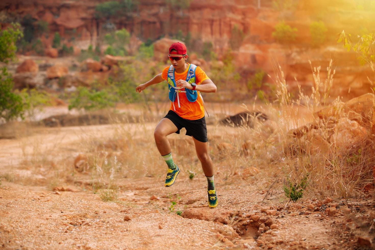 A man Runner of Trail and athlete's feet wearing sports shoes for trail running in the forest photo