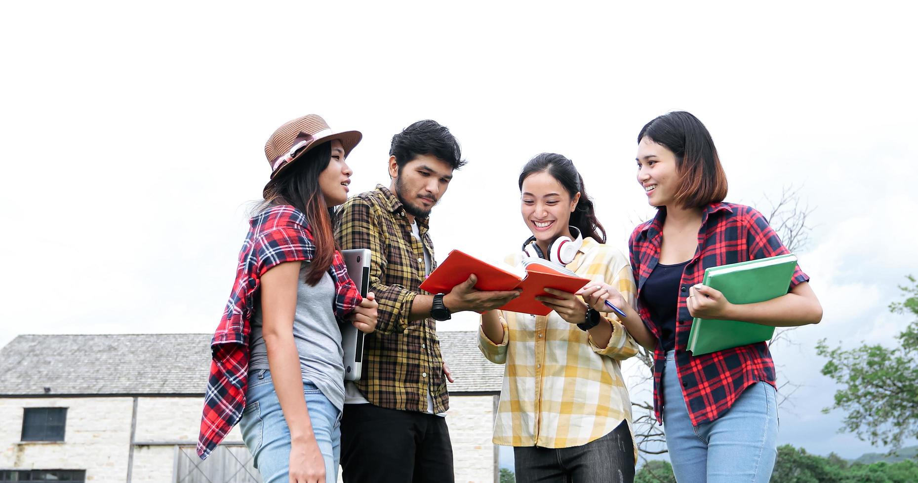 Group Students Smile and have fun It also helps to share ideas in the work and project. And also review the book before the exam outdoor in the garden. photo