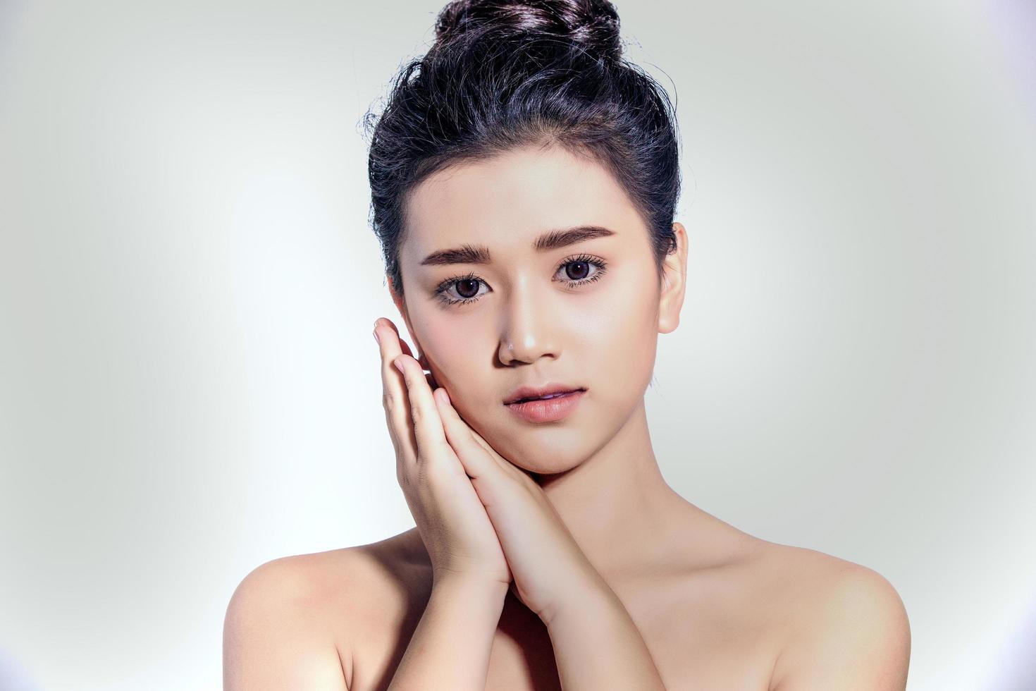 Asian women Beautiful with Clean Fresh Skin touch own face . Facial treatment . Cosmetology , beauty and spa photo