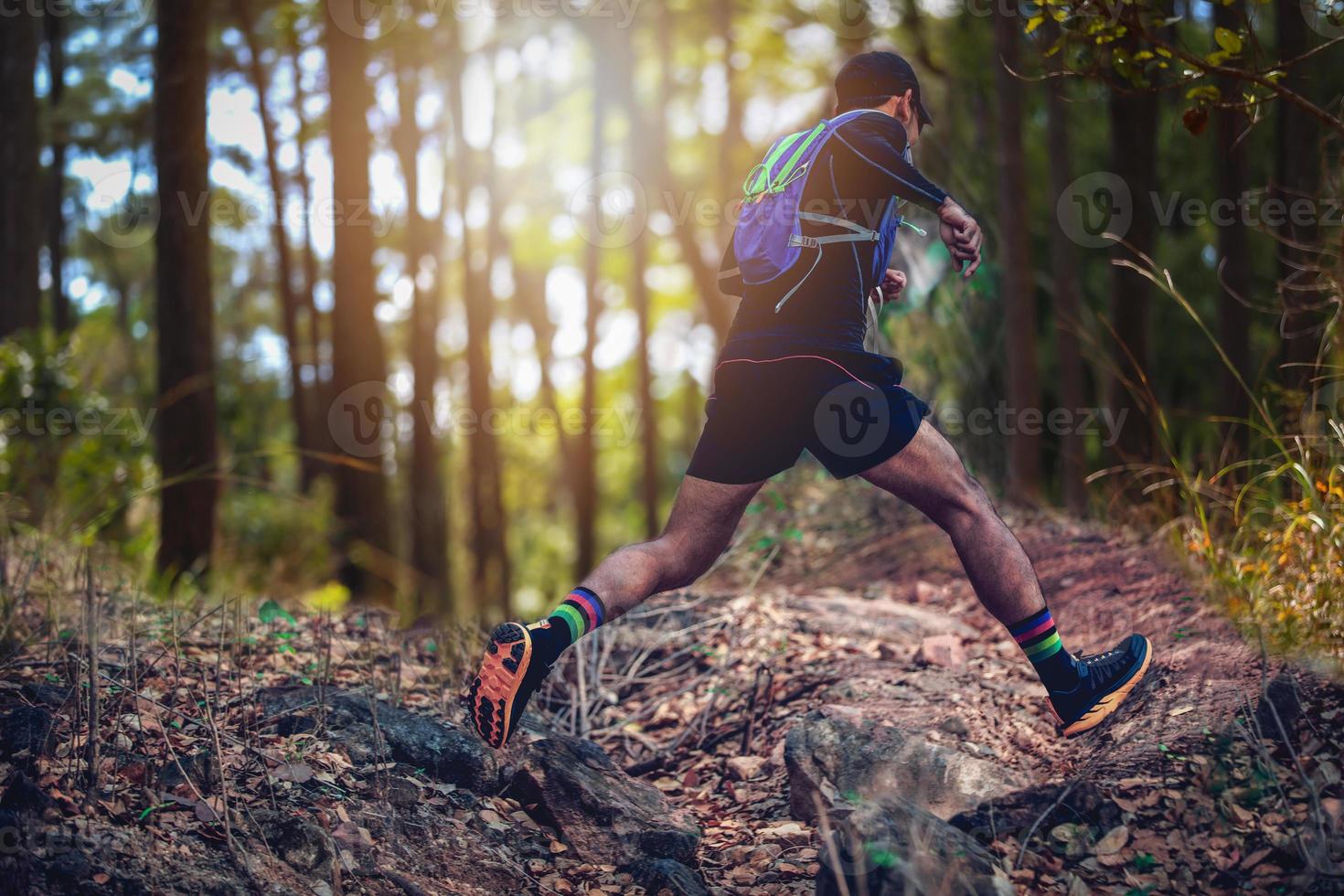 A man Runner of Trail . and athlete's feet wearing sports shoes for trail running in the forest photo