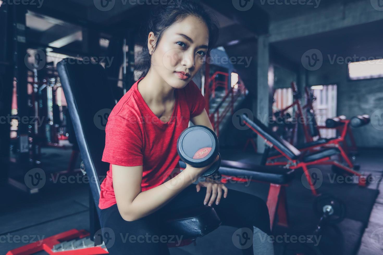 beautiful muscular fit woman exercising building muscles and fitness woman doing exercises in the gym. Fitness - concept of healthy lifestyle photo