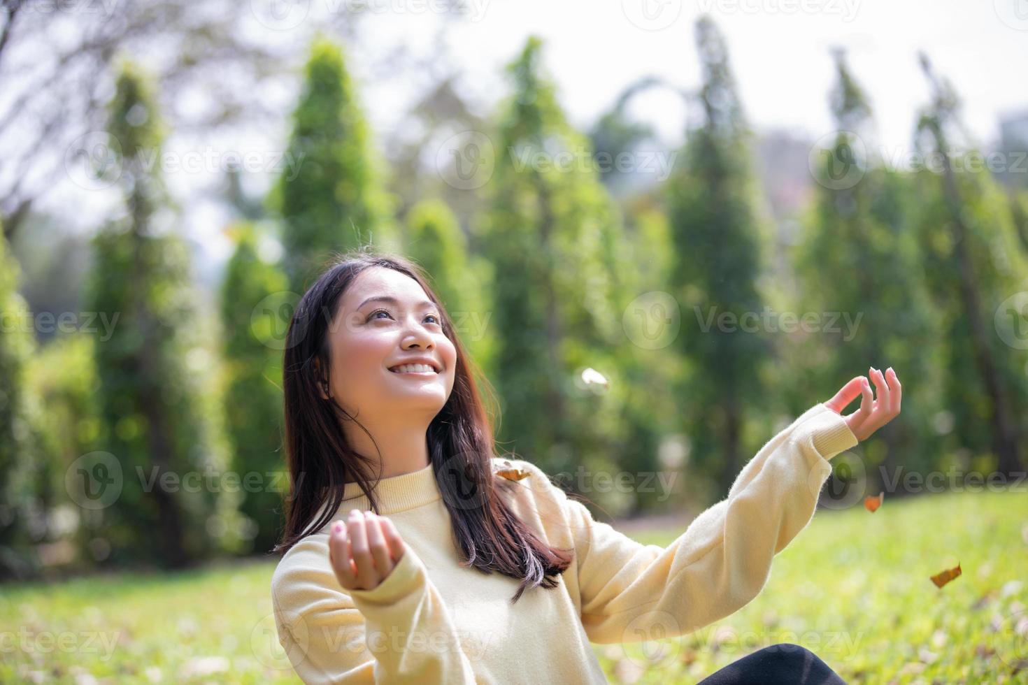 Beautiful Asian woman Smiling happy girl and wearing warm clothes winter and autumn portrait at outdoor in park photo