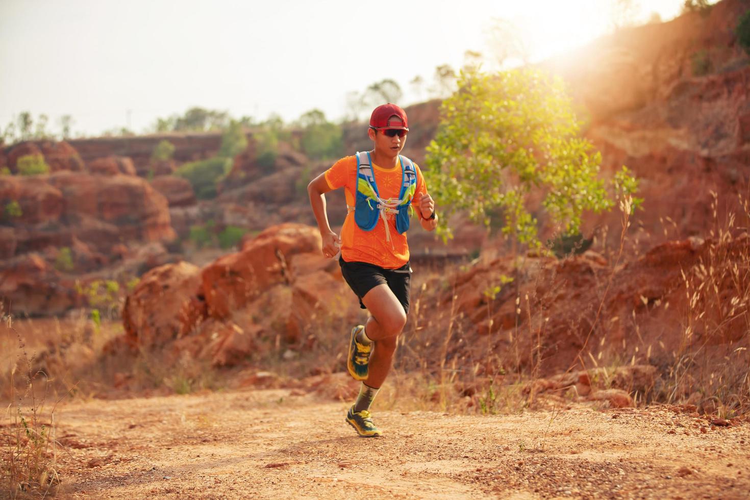 A man Runner of Trail . and athlete's feet wearing sports shoes for trail running in the mountains photo