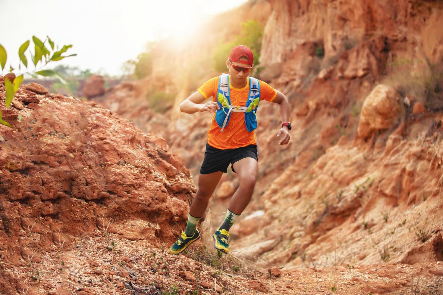 A man Runner of Trail . and athlete's feet wearing sports shoes for trail running in the mountains photo