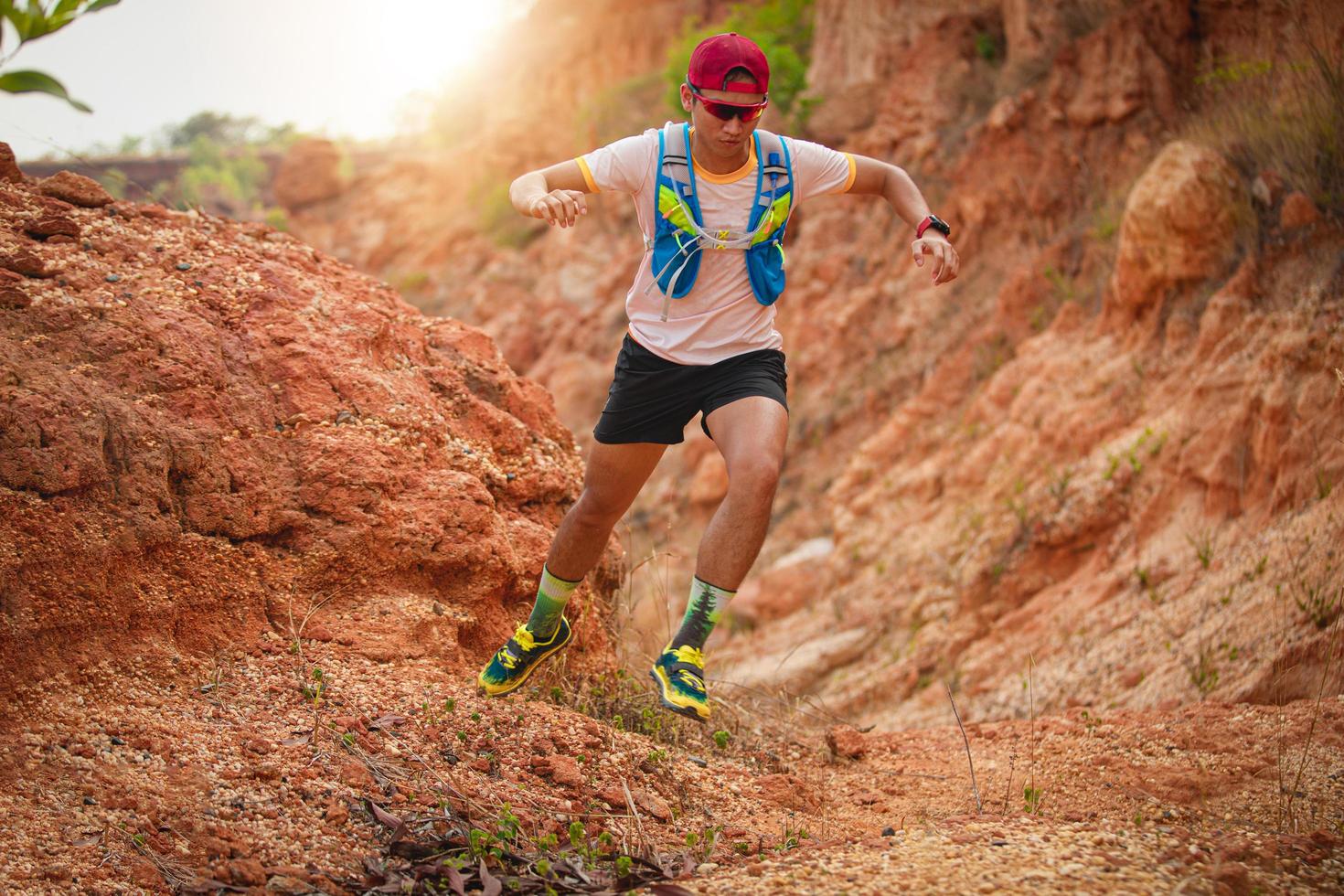 A man Runner of Trail . and athlete's feet wearing sports shoes for trail running in the mountains photo