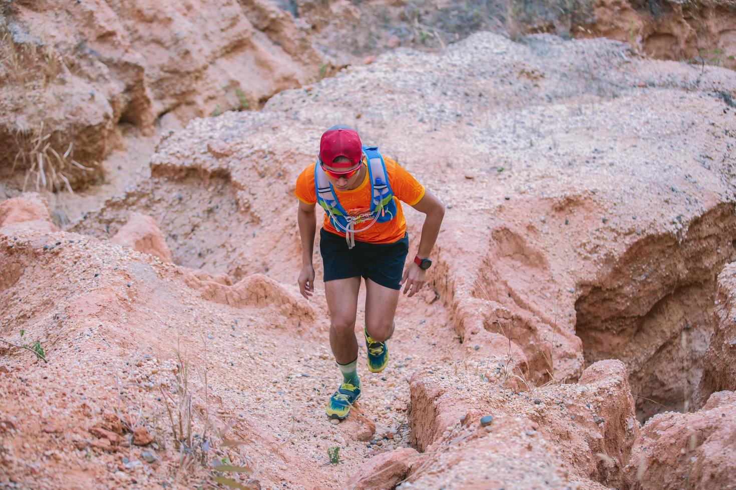 A man Runner of Trail . and athlete's feet wearing sports shoes for trail running in the mountains photo