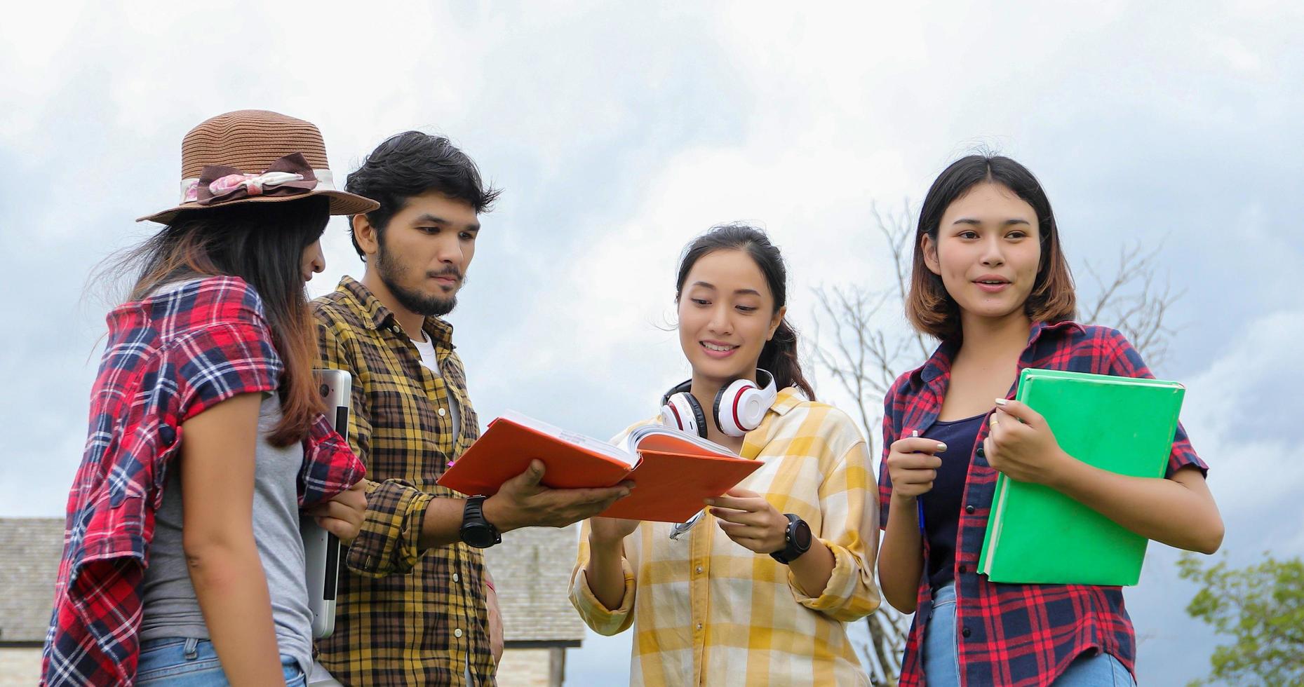 Group Students Smile and have fun It also helps to share ideas in the work and project. And also review the book before the exam outdoor in the garden. photo