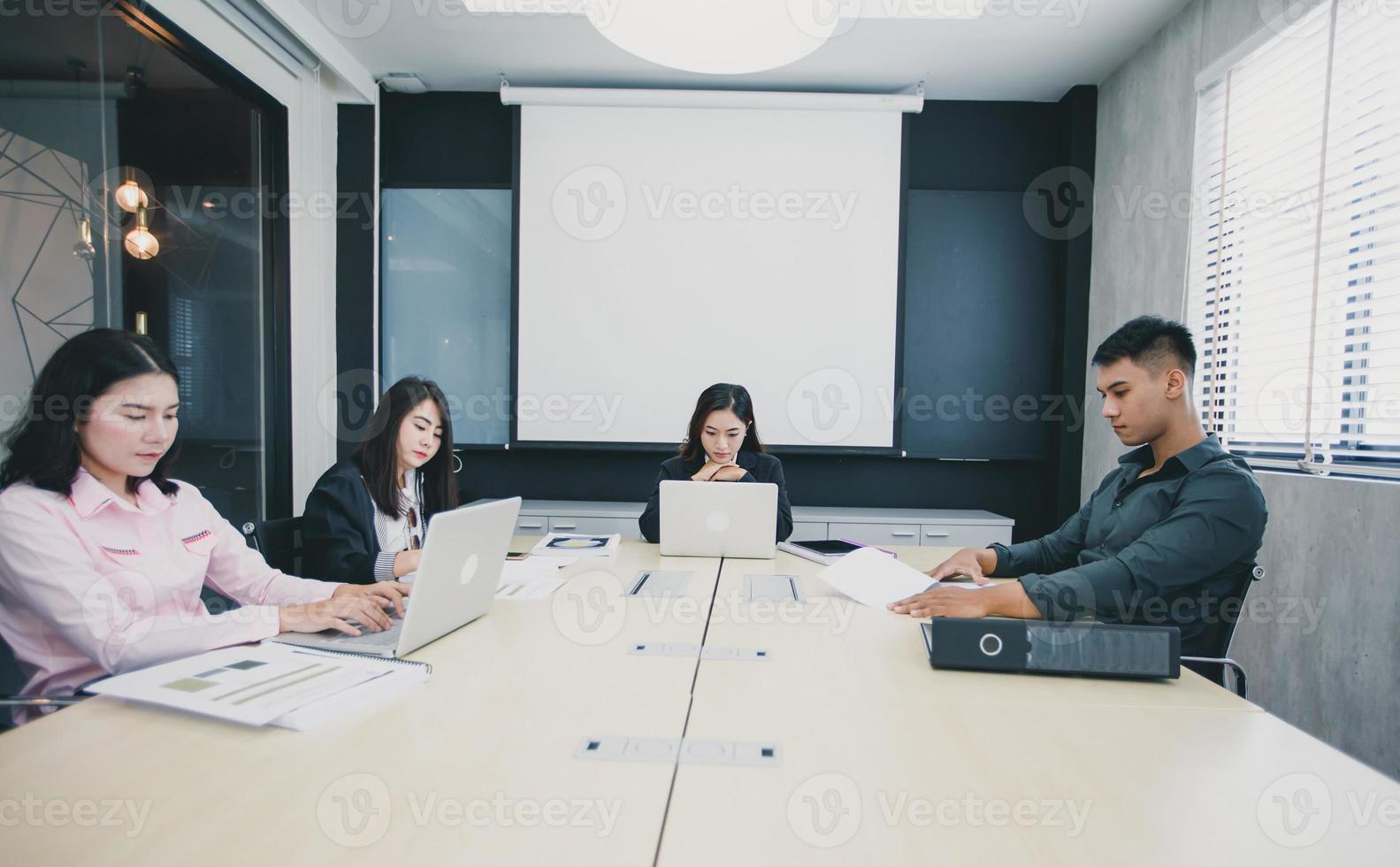 Asian businessmen and group using notebook for meeting serious about the work photo