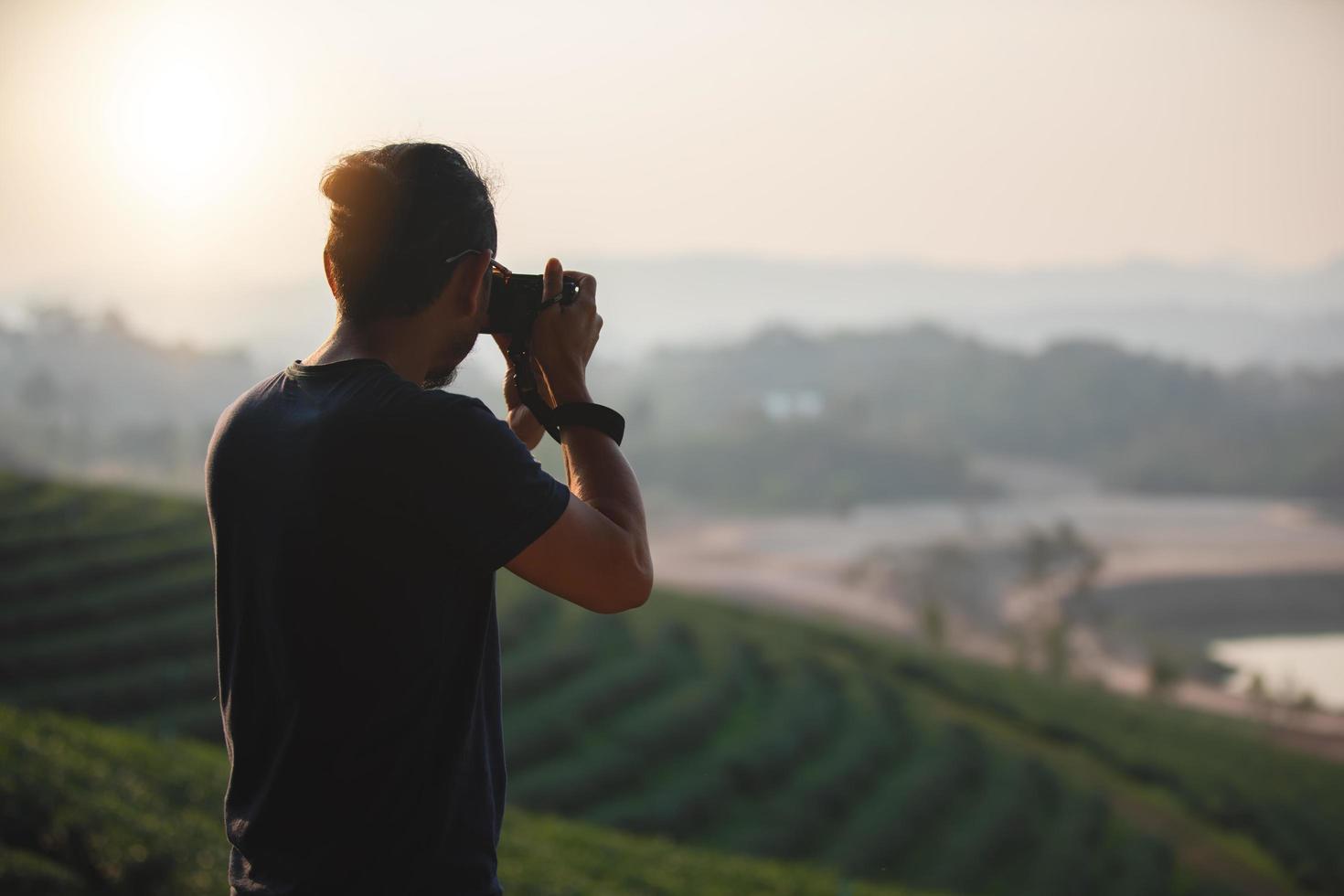 Asian men backpacks and traveler walking together and happy are taking photo on mountain  ,Relax time on holiday concept travel