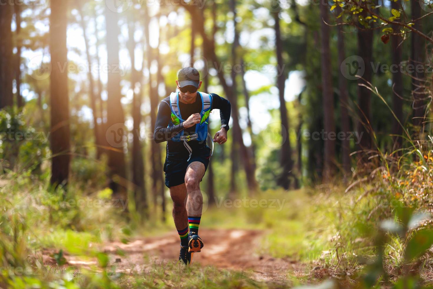 A man Runner of Trail . and athlete's feet wearing sports shoes for trail running in the forest photo