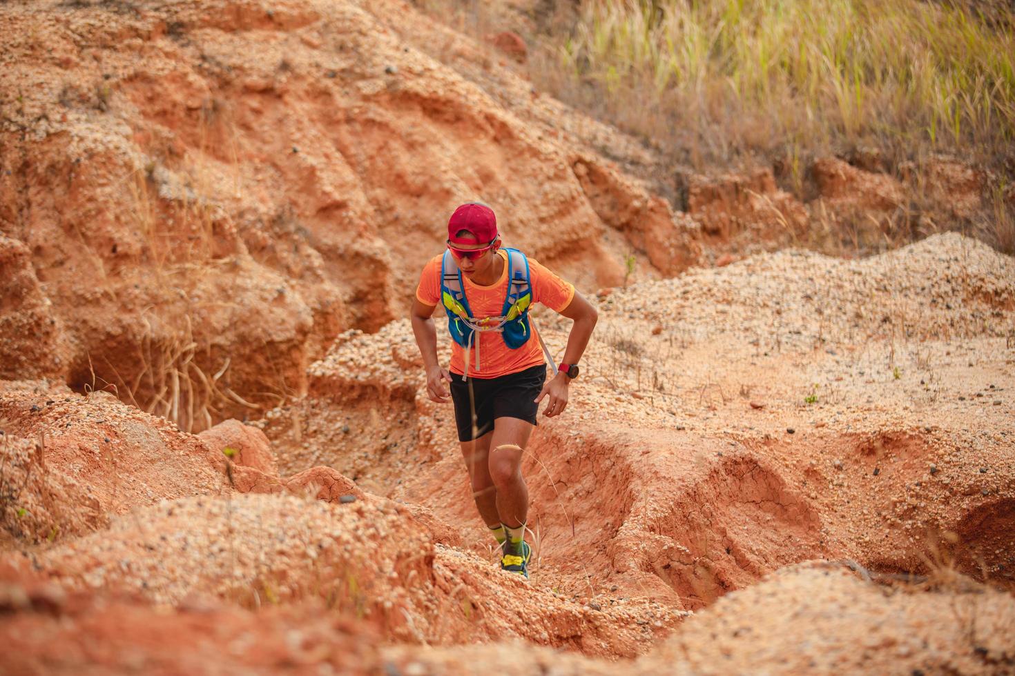 A man Runner of Trail . and athlete's feet wearing sports shoes for trail running in the mountains photo