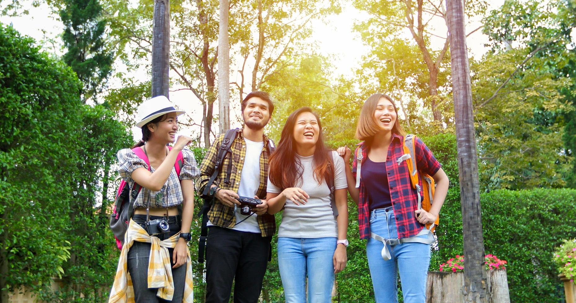 Asian Group of young people with friends backpacks walking together and happy friends are taking photo and selfie ,Relax time on holiday concept travel