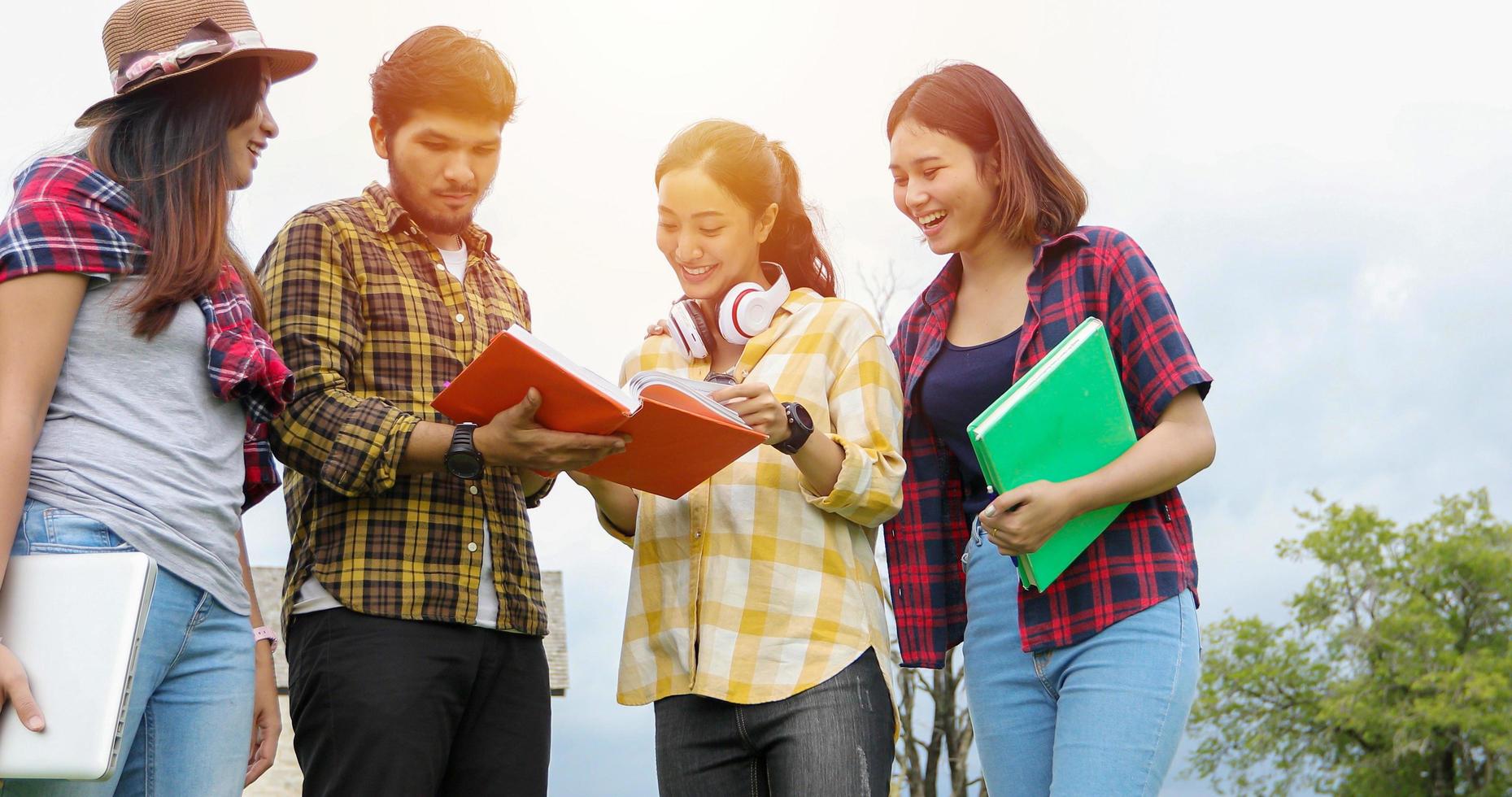 Group Students Smile and have fun It also helps to share ideas in the work and project. And also review the book before the exam outdoor in the garden. photo