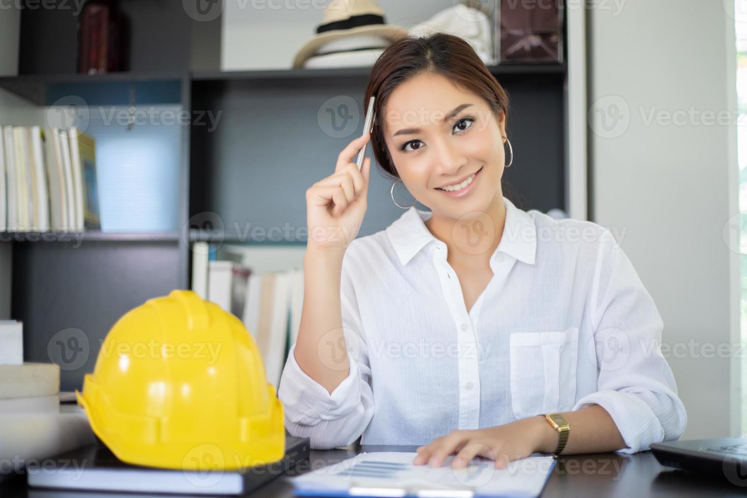 Female engineers are thinking to create new jobs and are smiling and working happy photo