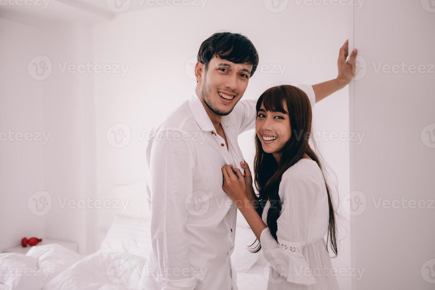 couples lover Laying On Bed room Happiness Lifestyle and smiling girl relaxing in white bed photo