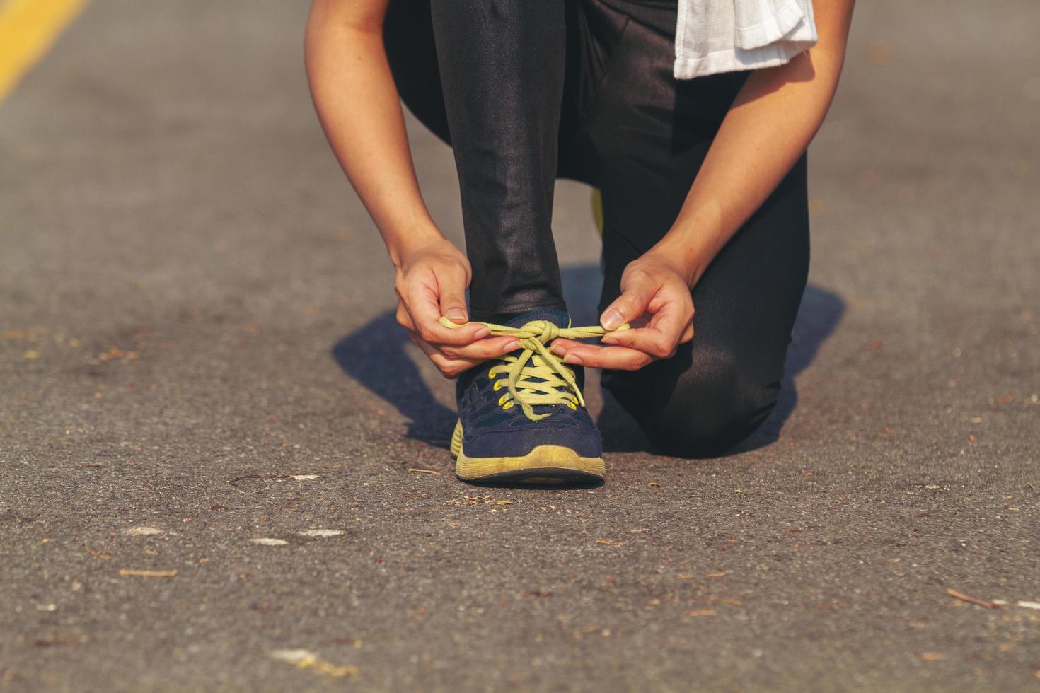women asia sport, fitness, exercise and lifestyle concept - runner woman lacing trainers shoes photo
