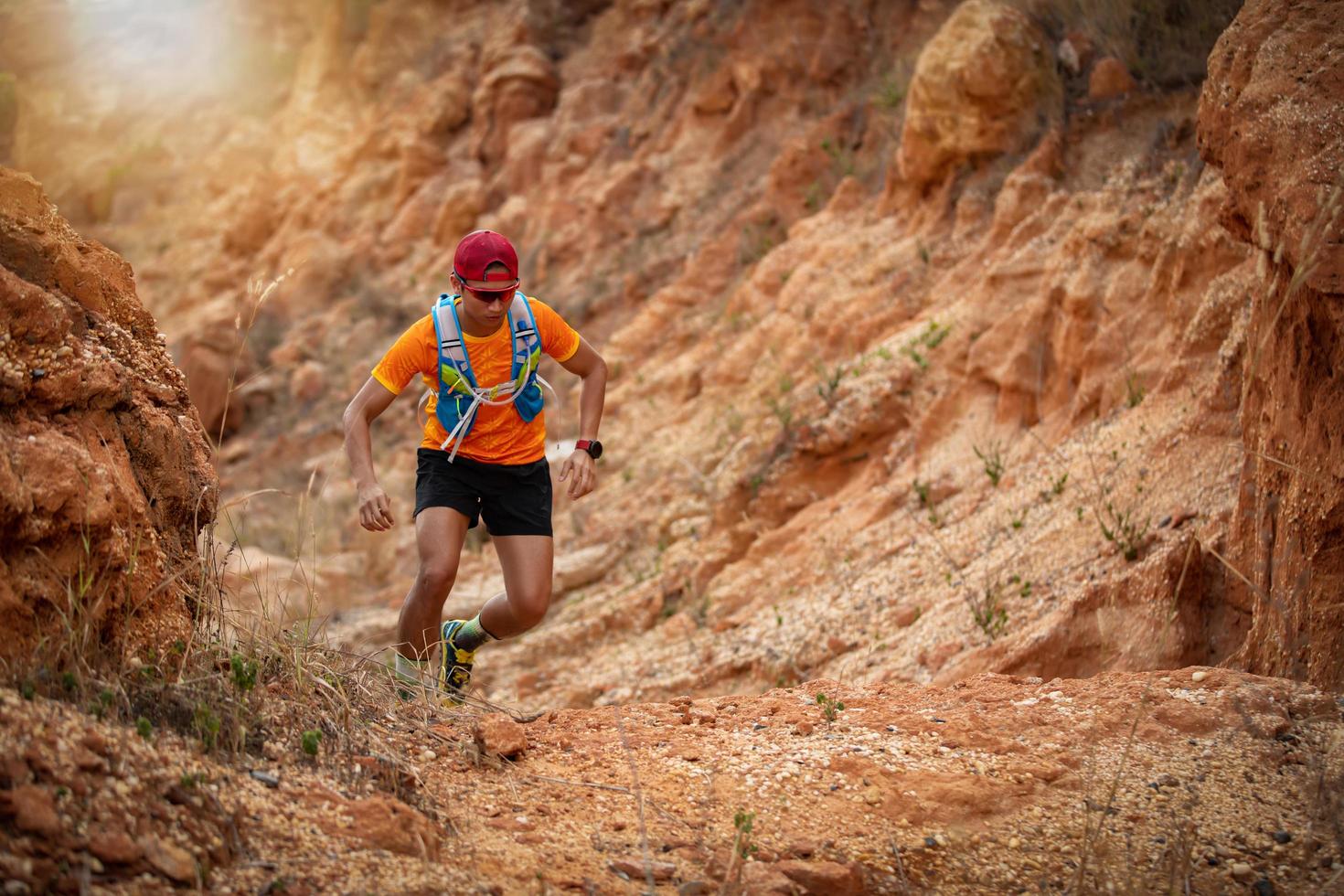 A man Runner of Trail . and athlete's feet wearing sports shoes for trail running in the forest photo
