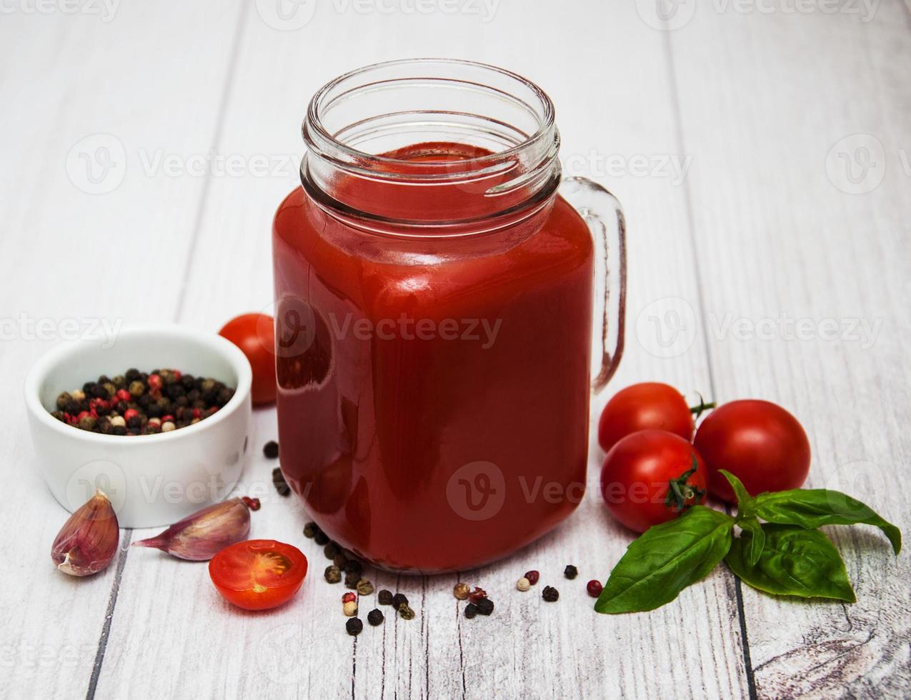 Jars with tomato juice photo