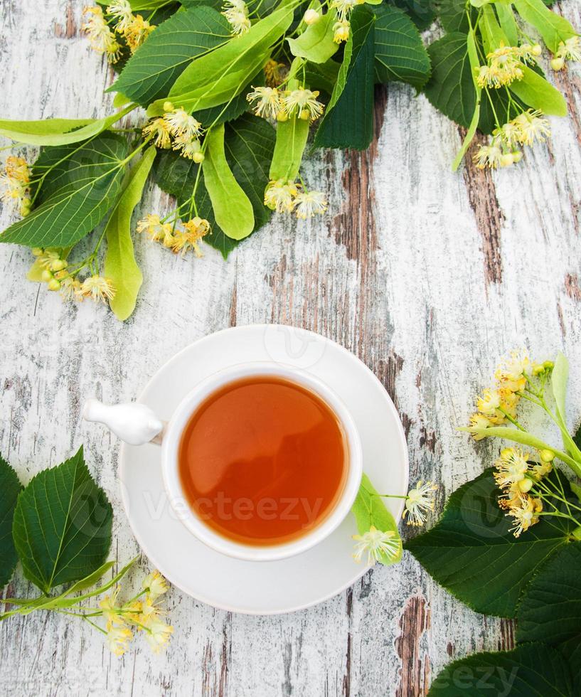 cup of herbal tea with linden flowers photo