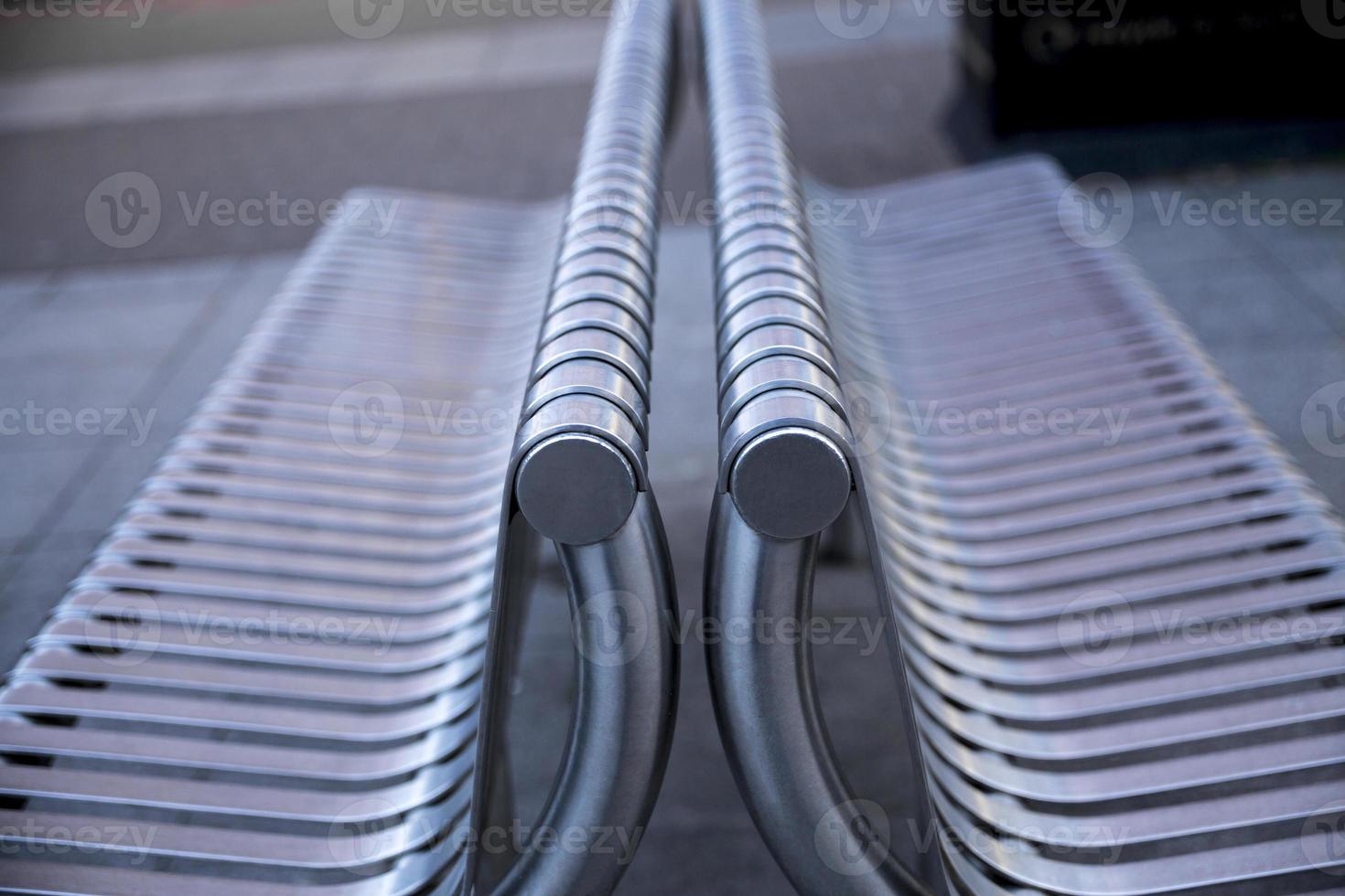 Close up of contemporary modern stainless steel street or park bench. Selective Focus. photo