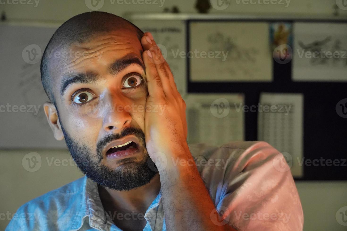 a young man shocked due to hair loss and sad photo