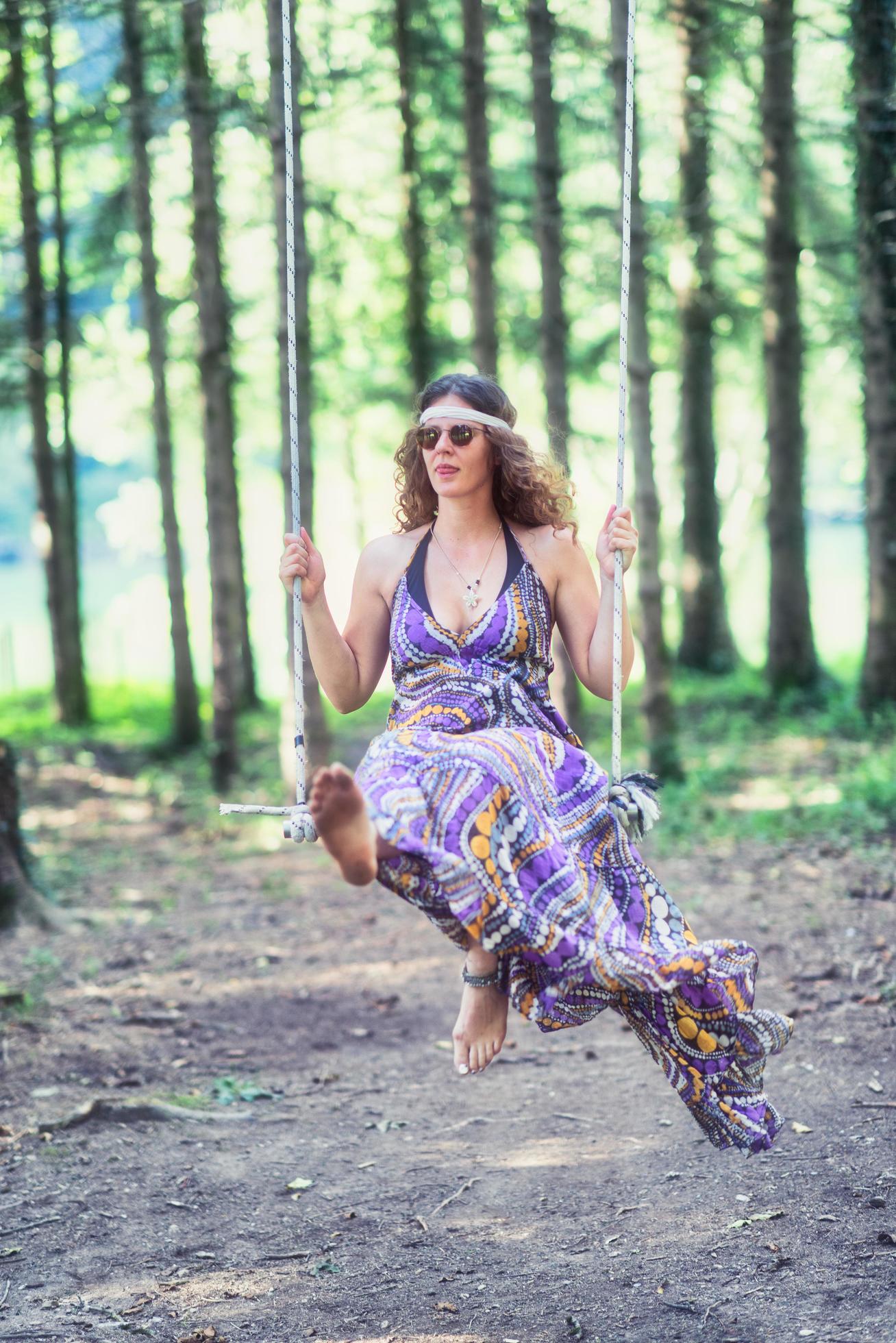 https://static.vecteezy.com/system/resources/previews/005/254/387/large_2x/hippie-style-girl-swings-on-swing-in-the-woods-free-photo.jpg