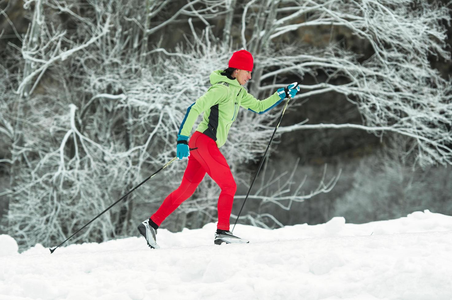 Woman cross-country skiing classic technique photo