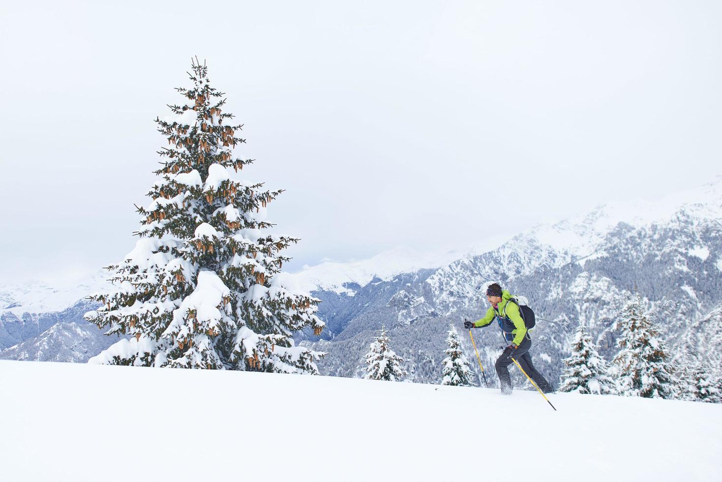 Ski touring with lots of fresh snow one man uphill photo