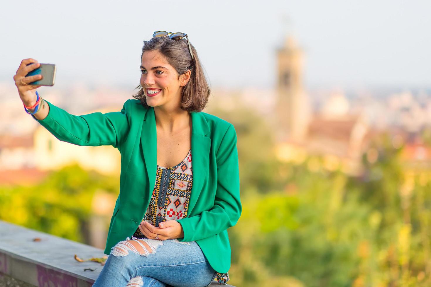 Young beautiful smiling girl taking selfies with mobile phone photo