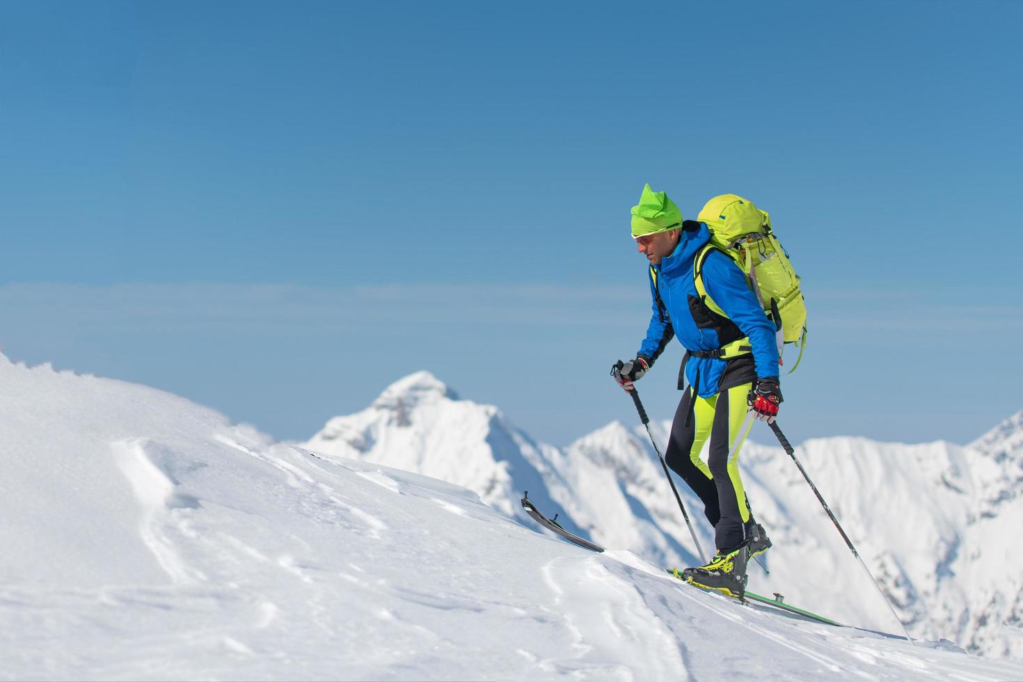 Cross country skiing man alone towards the mountain photo