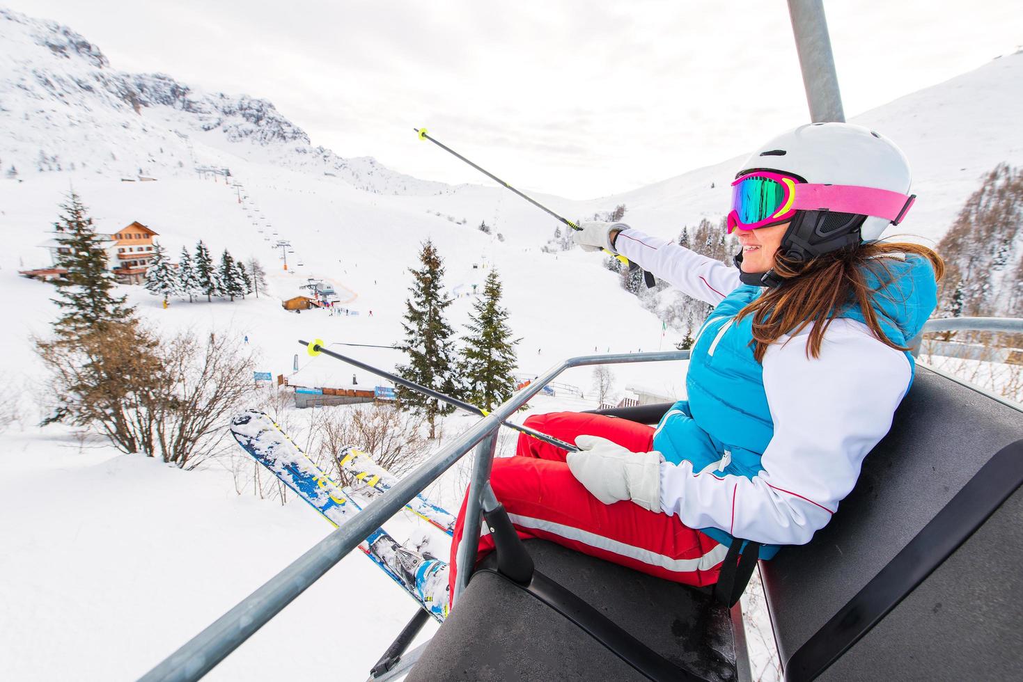 Female skier chair lift in ski area photo