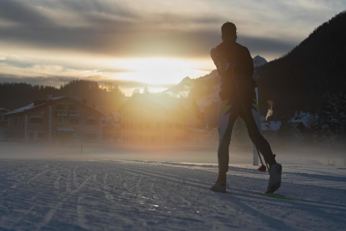 Cross-country skiing at sunset in a tourist resort photo