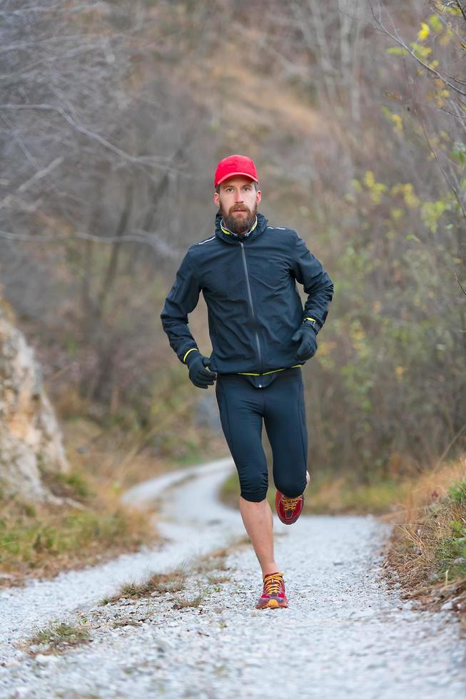 Trail mountain athlete during training in dirt road photo