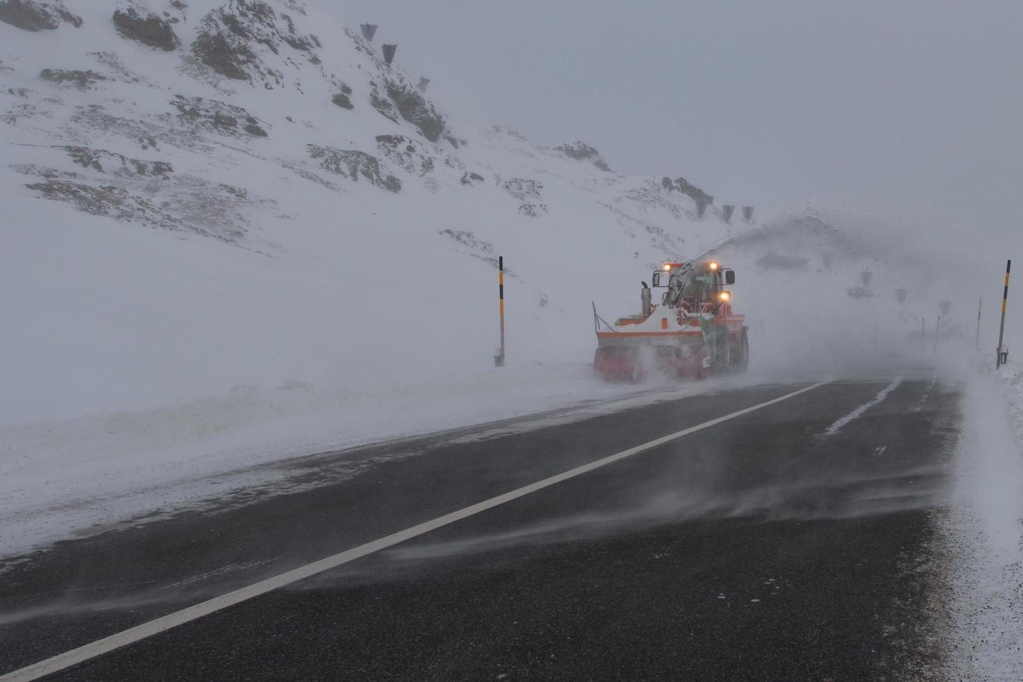 Snowplow in mountain road photo