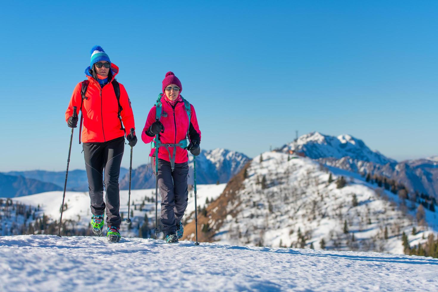 A pair of female friends during a snow hike photo