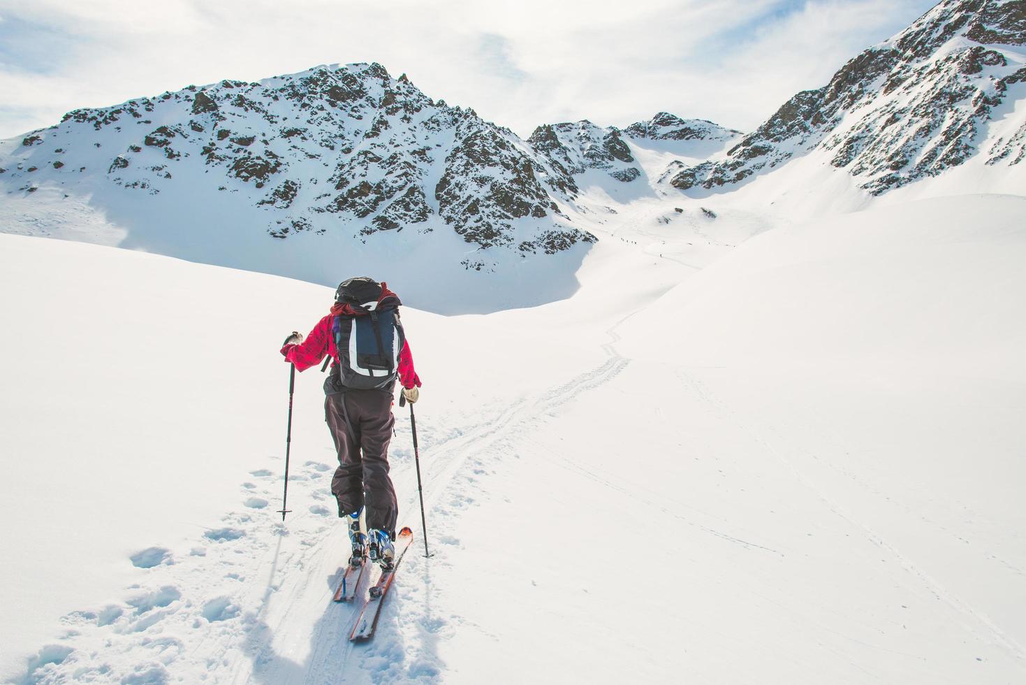 One person follows the track of ascent with ski touring photo