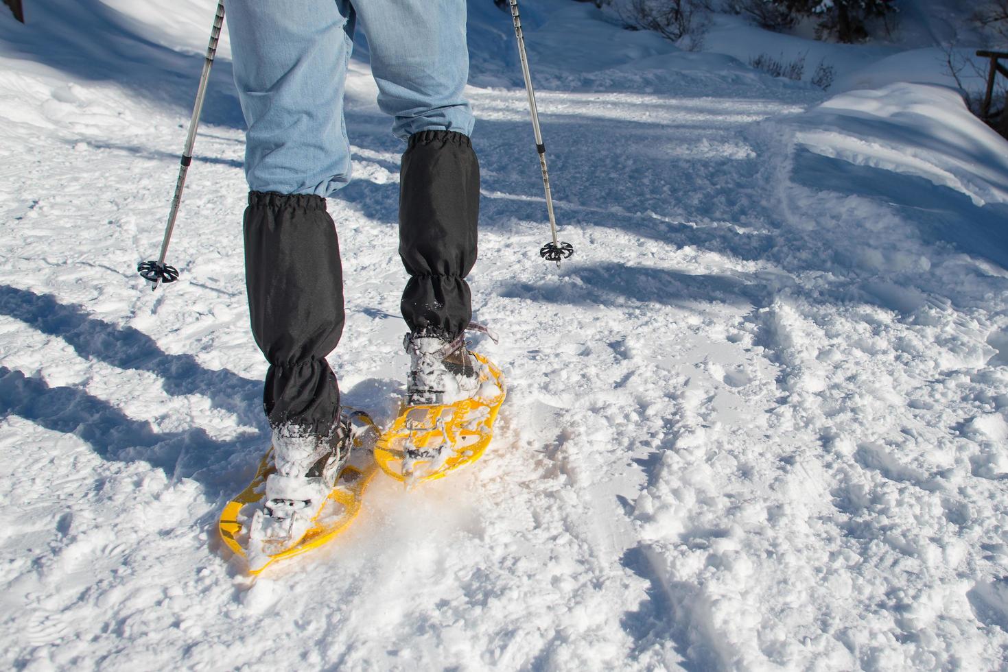 Detail of a hiker with snowshoes photo