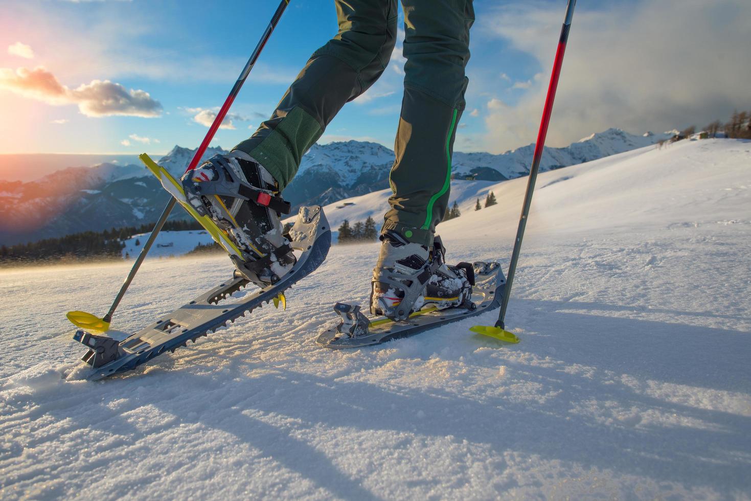 Hiker in spring mountains snowshoeing photo