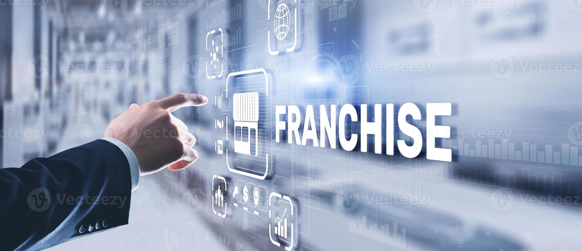 Businessman hand touching inscription Franchise marketing system photo