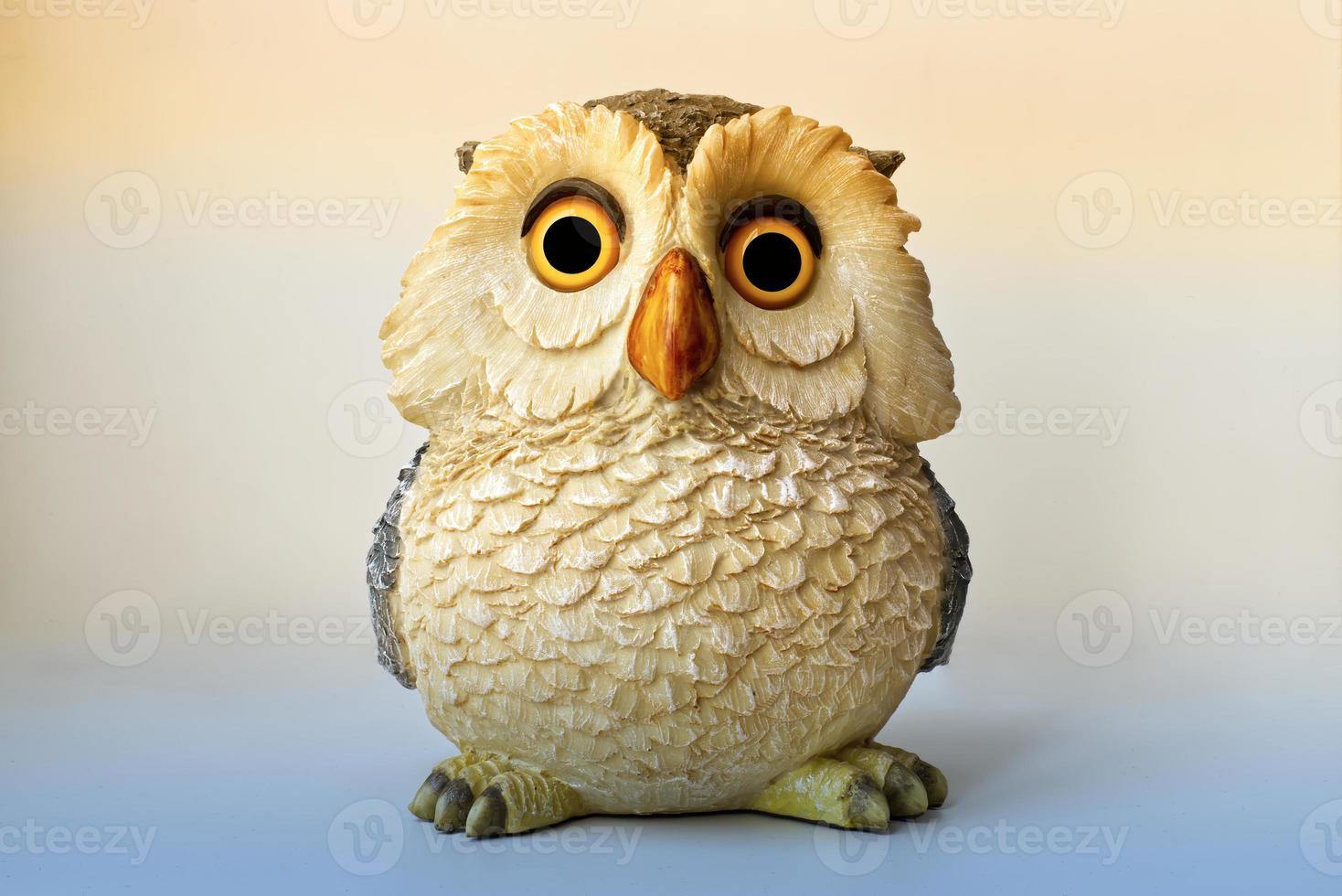 Statue of an Owl isolated on bright background. photo