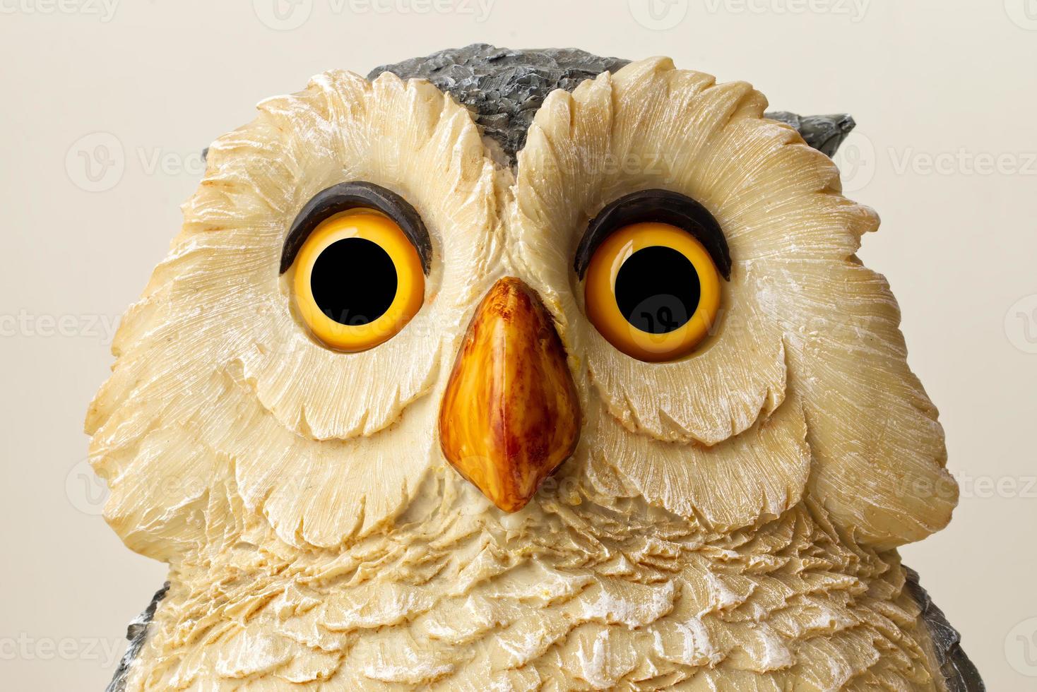 Statue of an Owl isolated on bright background. Close up. photo