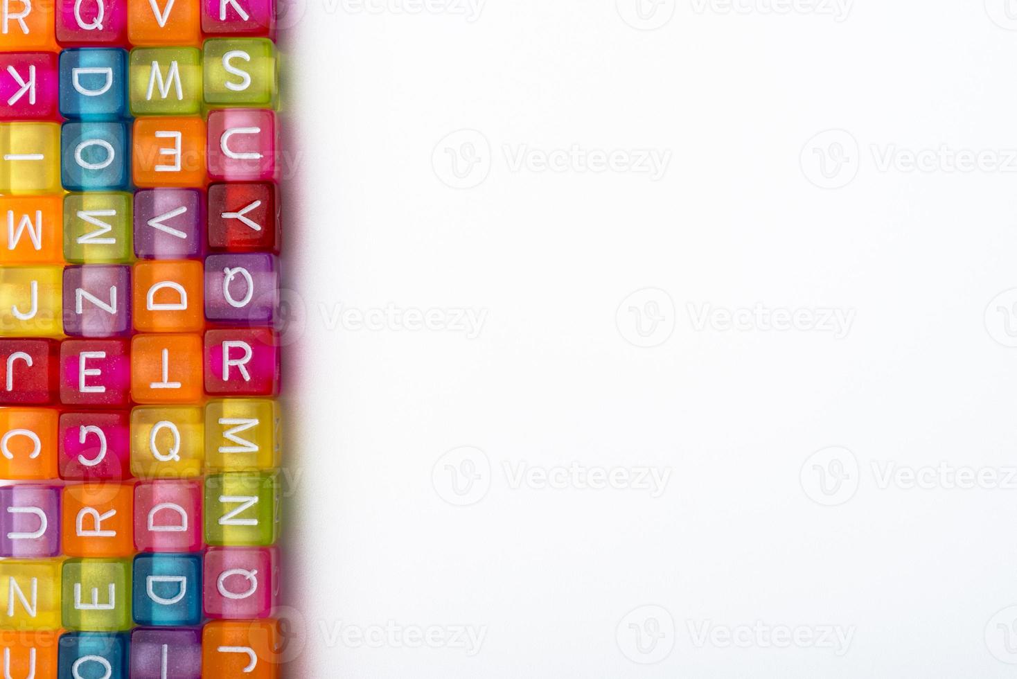 Many colorful decorative cubes with letters on a white background. photo