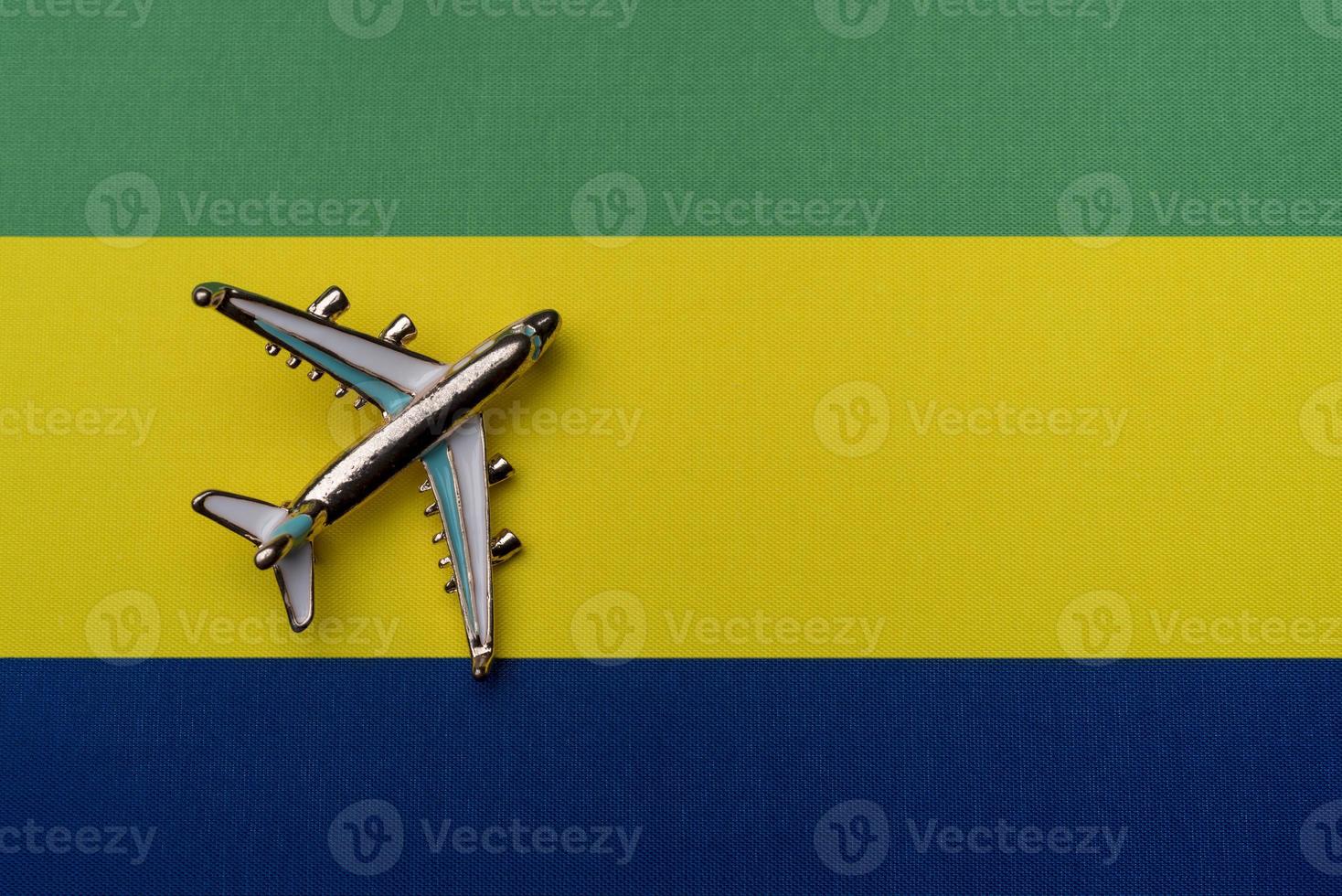 Plane over the flag of Gabon, the concept of travel. photo